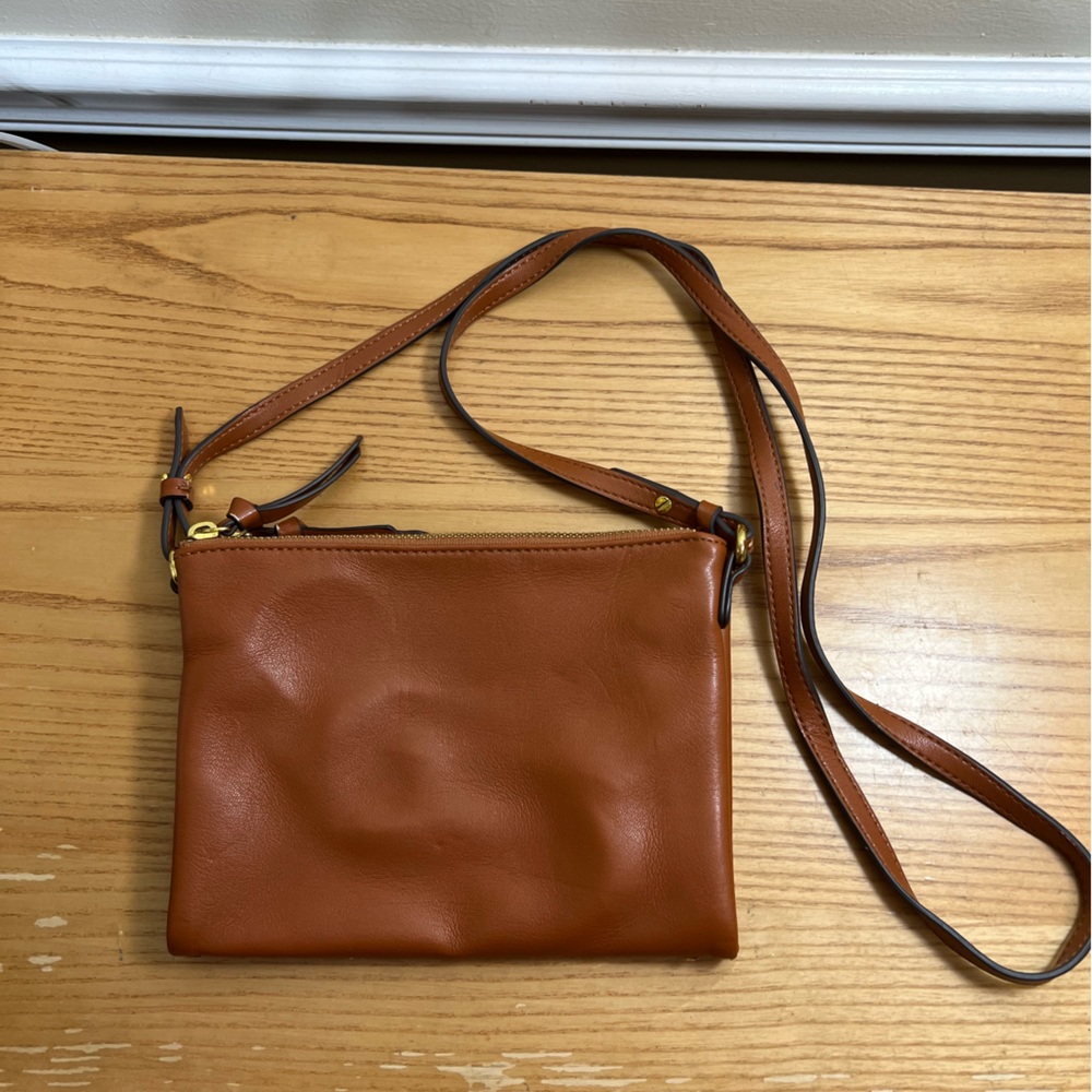 Brown crossbody purse with two 8” by 6” adjustable pockets